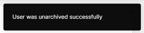 Black rectangular pop-up notification with the text "User was unarchived successfully".