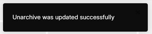 Black rectangular pop-up notification with the text "Unarchive was updated successfully".